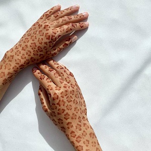 Adidas collaborates with Muslim henna artist Azra Khamissa to create trainer patterns.